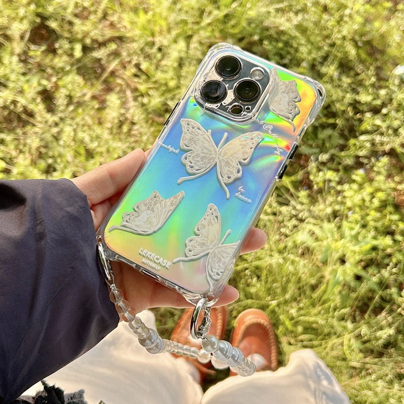 芝生の上でバタフライiPhoneケースとパールチェーンを見せた近接イメージ