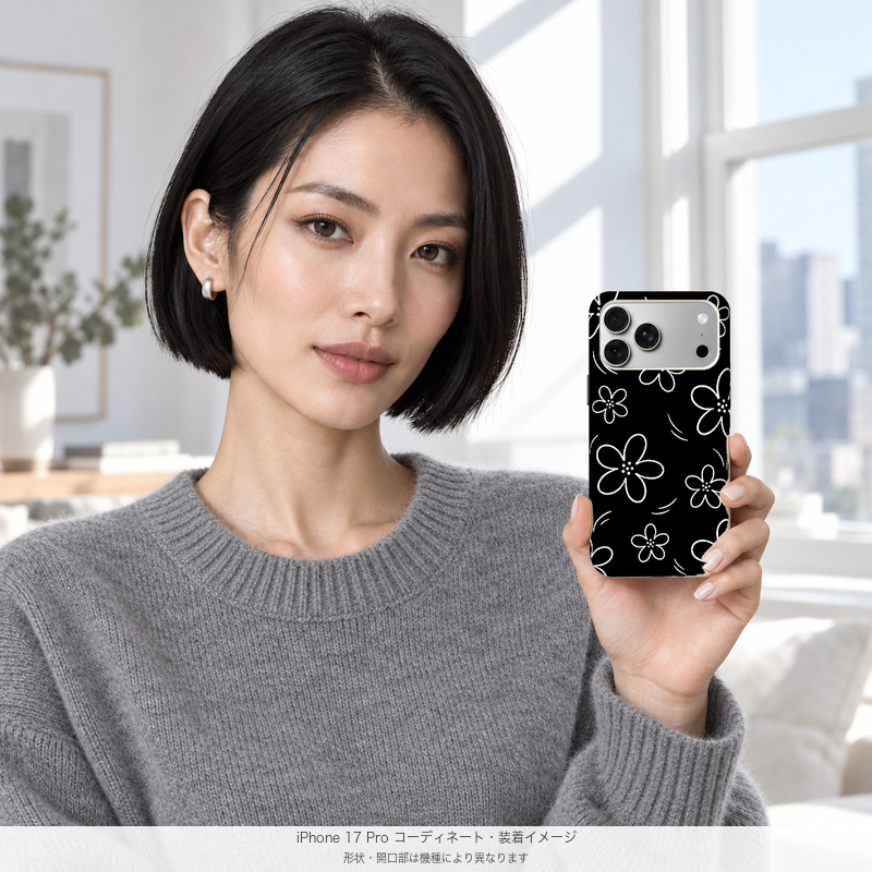 ブラックフラワードゥードル iPhone 17 Proを手に持つモデル 装着イメージ