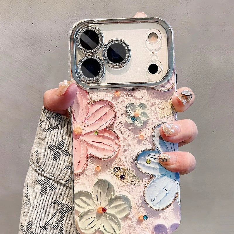 油絵タッチの立体フラワー柄iPhoneケース ラメ入りレンズフレーム付きを手に持つ