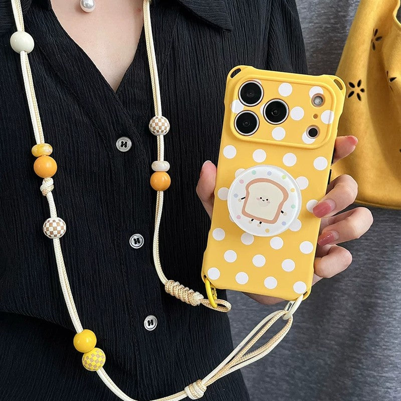 イエロー水玉iPhoneケースとショルダーストラップの近接イメージ